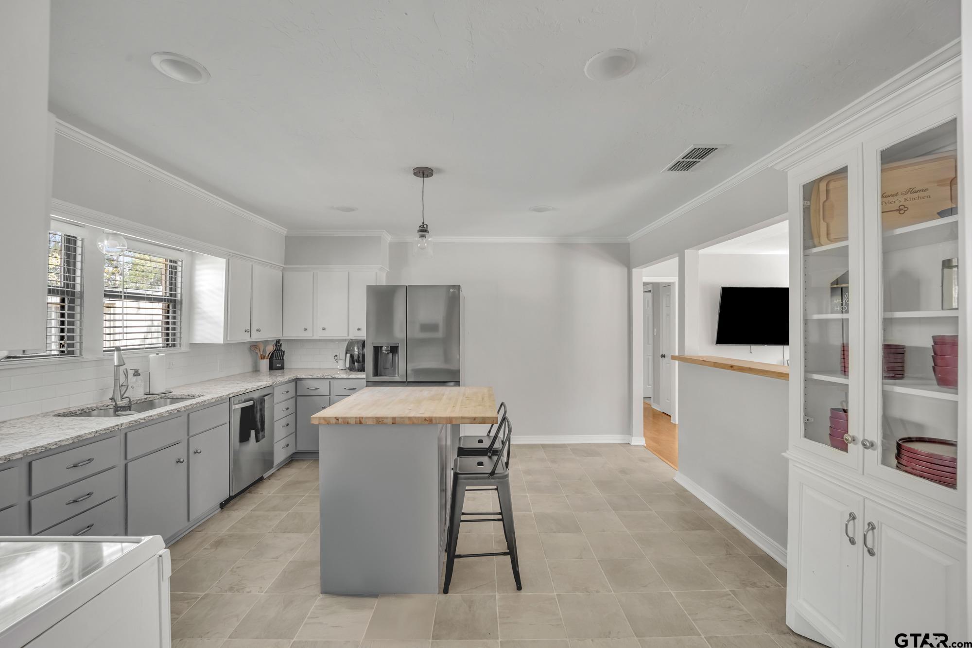 3601 Dumas Road Longview, TX 75604 - Photo 14 of 27 a large white kitchen with a stove a sink a microwave and a refrigerator