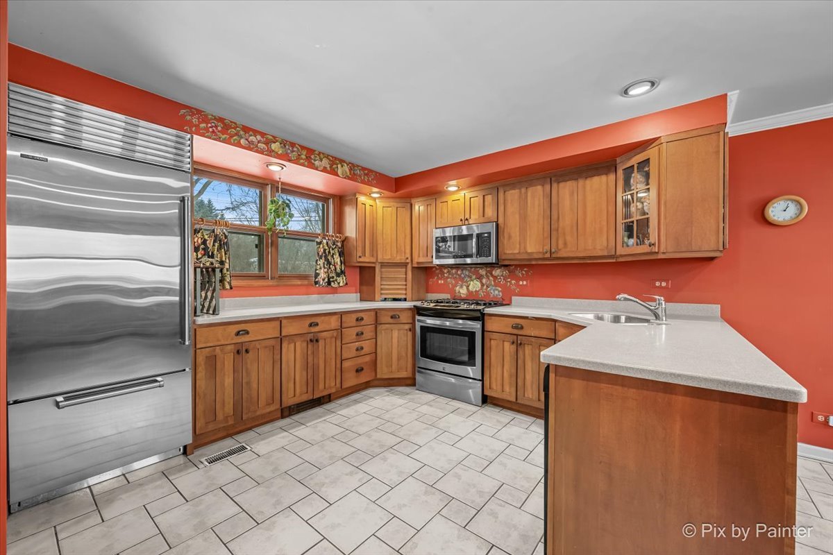 11N575 Rohrssen Road Elgin, IL 60120 - Photo 15 of 58 a kitchen with stainless steel appliances granite countertop a refrigerator and a stove top oven