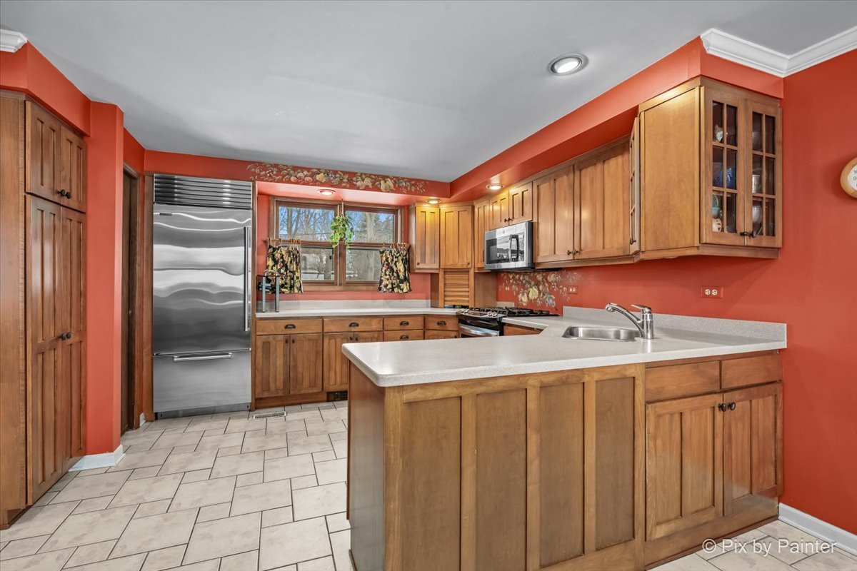 11N575 Rohrssen Road Elgin, IL 60120 - Photo 18 of 58 a kitchen with stainless steel appliances granite countertop a sink a stove and a refrigerator