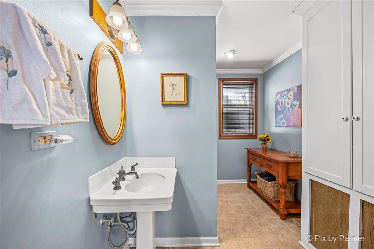 11N575 Rohrssen Road Elgin, IL 60120 - Photo 21 of 58 a bathroom with a sink a mirror and a window