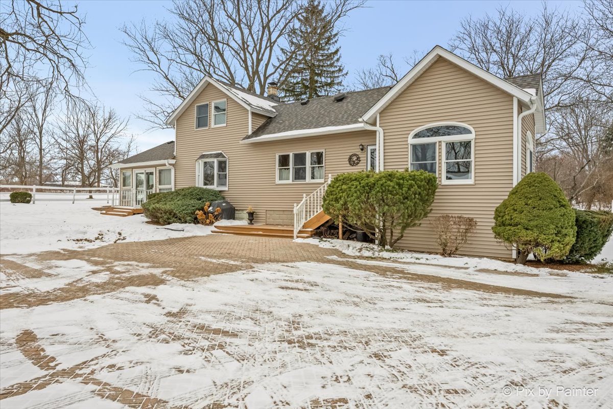 11N575 Rohrssen Road Elgin, IL 60120 - Photo 35 of 58 a front view of a house with a yard covered in snow