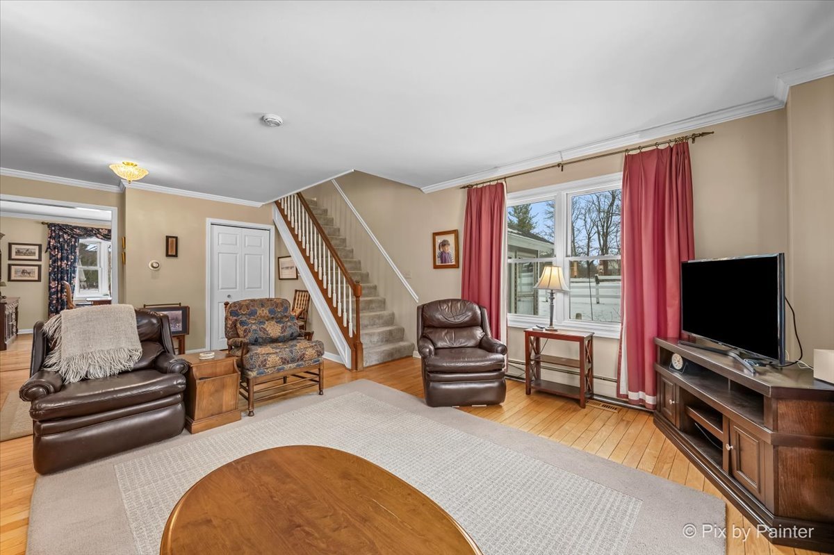 11N575 Rohrssen Road Elgin, IL 60120 - Photo 8 of 58 a living room with furniture and a flat screen tv
