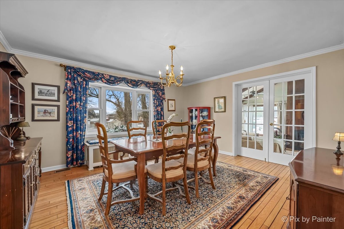 11N575 Rohrssen Road Elgin, IL 60120 - Photo 9 of 58 a view of a dining room with furniture and wooden floor