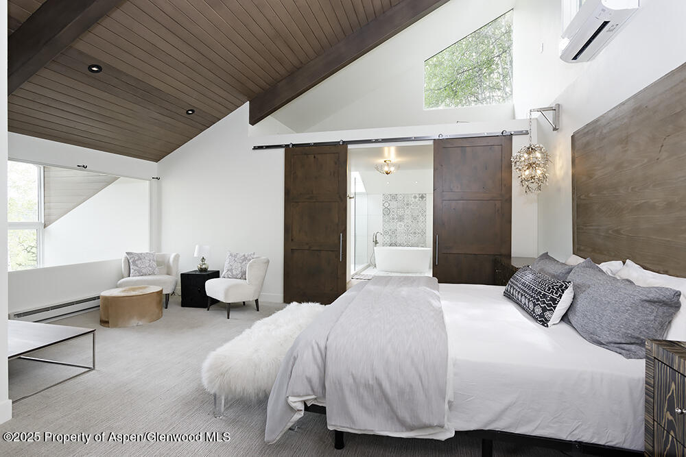 333 Faraway Road Snowmass Village, CO 81615 - Photo 14 of 29 a bedroom with a bed and a large window