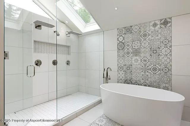 a bathroom with a bathtub and shower