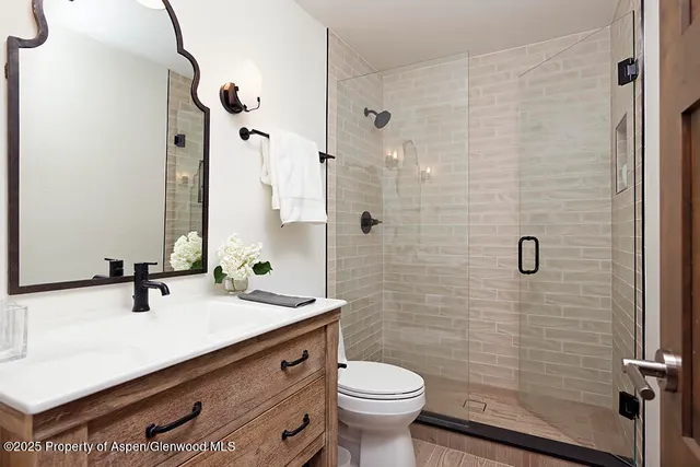 a bathroom with a sink toilet and shower