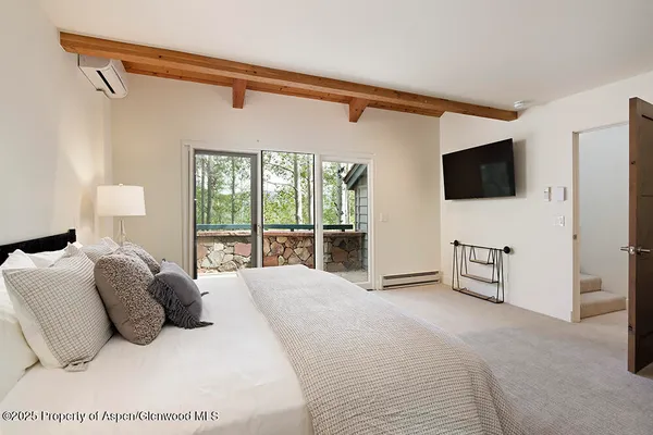 a large white bed in a white room