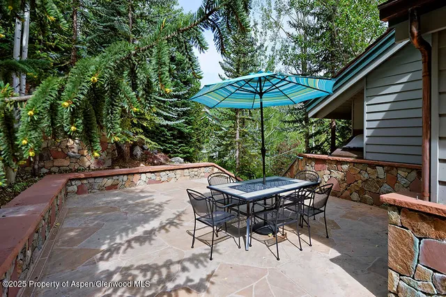 a view of backyard of house with seating space