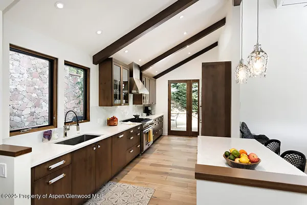 a large white kitchen with a large window