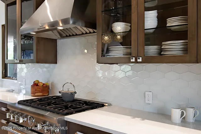 a kitchen with stainless steel appliances granite countertop a stove and a microwave