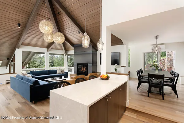 a kitchen with a sink a stove and chairs