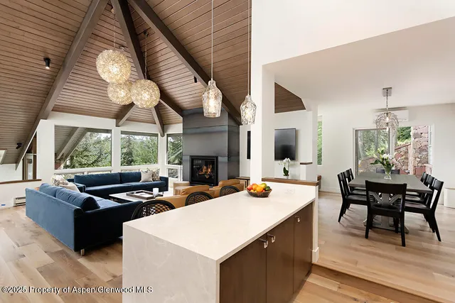 a kitchen with a sink a stove and chairs