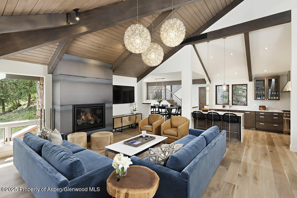333 Faraway Road Snowmass Village, CO 81615 - Photo 7 of 29 a living room with furniture a fireplace and large windows