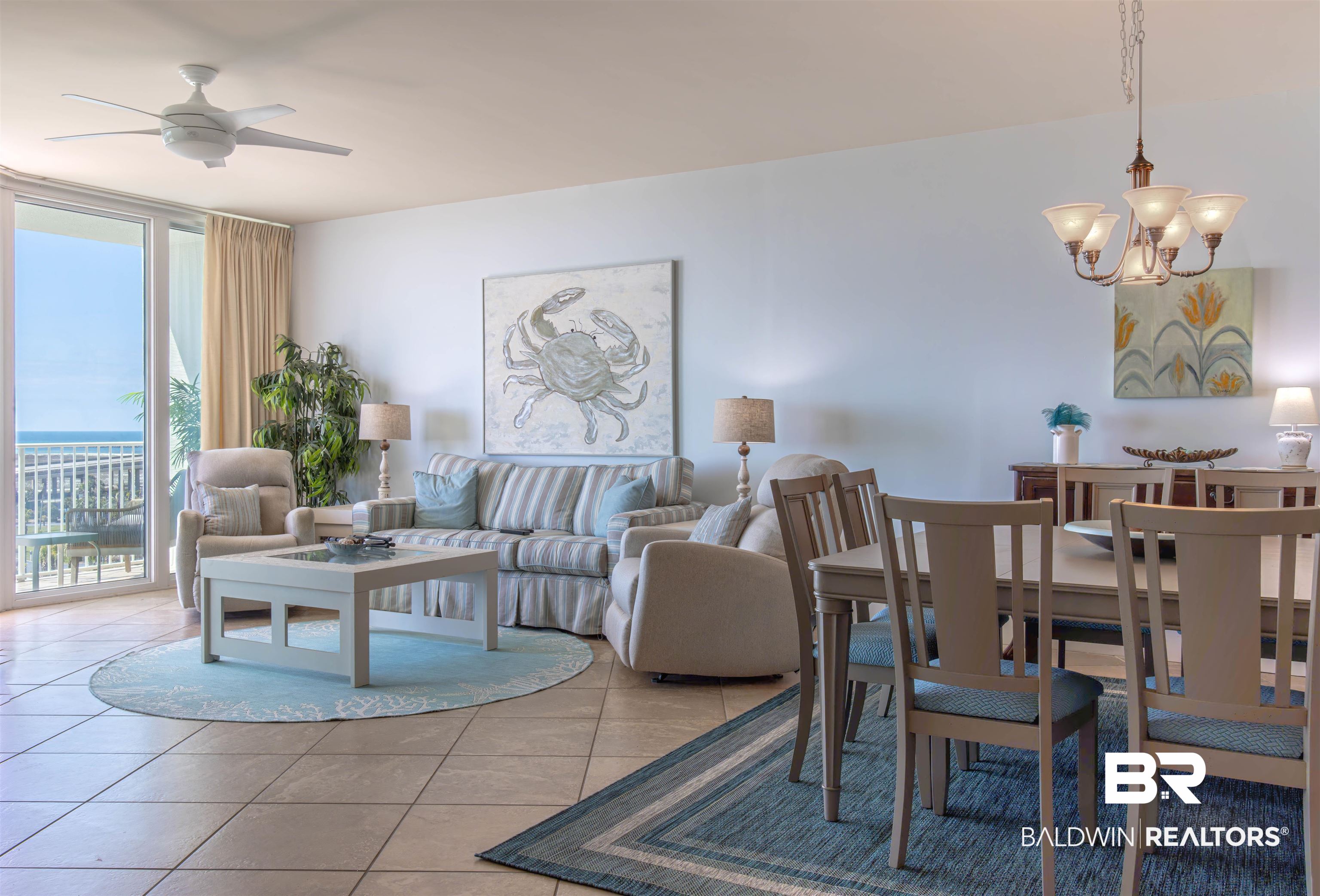 28107 Perdido Beach Boulevard, Unit D714 Orange Beach, AL 36561 - Photo 3 of 88 Dining room featuring expansive windows, light tile patterned flooring, and ceiling fan with notable chandelier