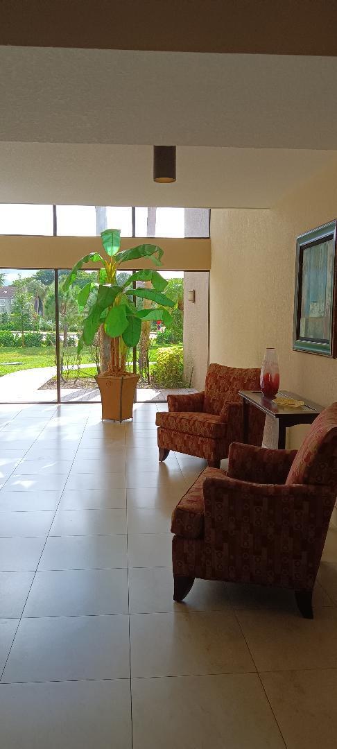 5749 Camino Del Sol, Unit 202 Boca Raton, FL 33433 - Photo 5 of 39 a living room with furniture and a large window