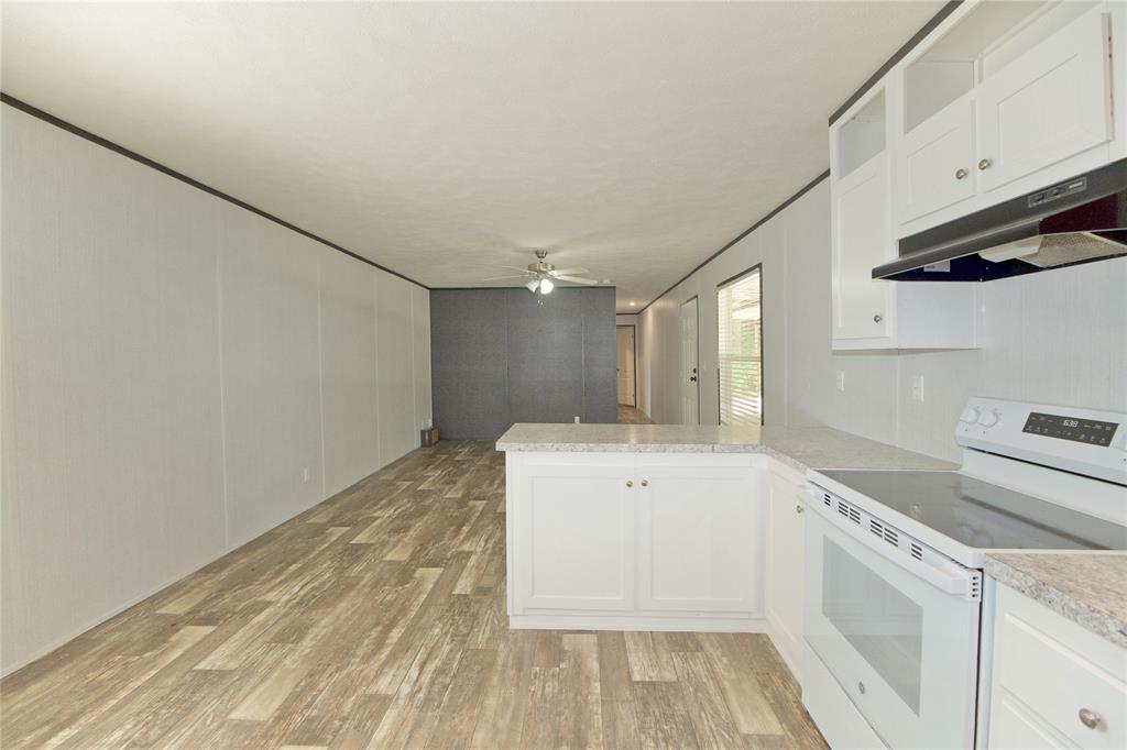 60 Tecumseh Road Valley View, TX 76272 - Photo 15 of 20 Kitchen featuring white cabinetry, light-toned countertops, and a white electric range