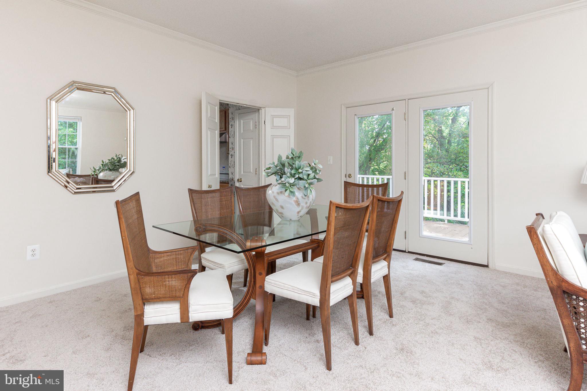 118 Queensberry Road Baltimore, MD 21237 - Photo 5 of 38 Dining room features doors to side deck