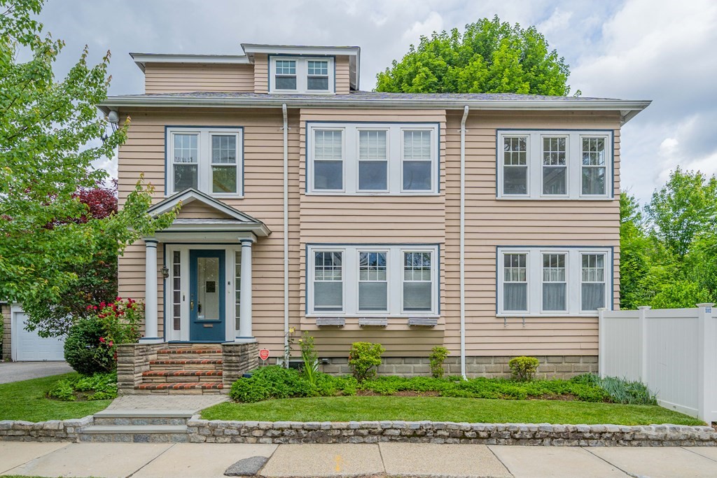 a house that has a tree in front of it