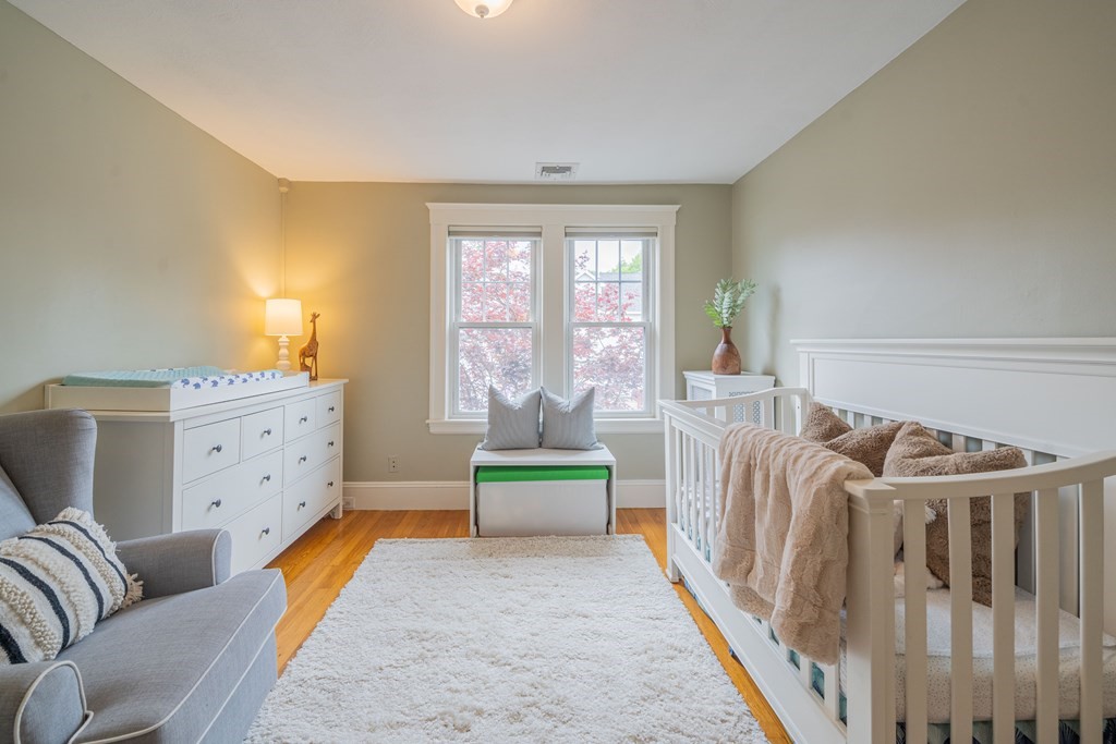 7 Maynard Street, Unit 2 Arlington, MA 02474 - Photo 25 of 42 a spacious bedroom with furniture and a large window