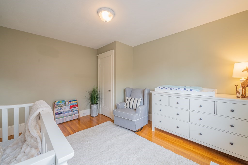 7 Maynard Street, Unit 2 Arlington, MA 02474 - Photo 27 of 42 a bedroom with a bed and a couch