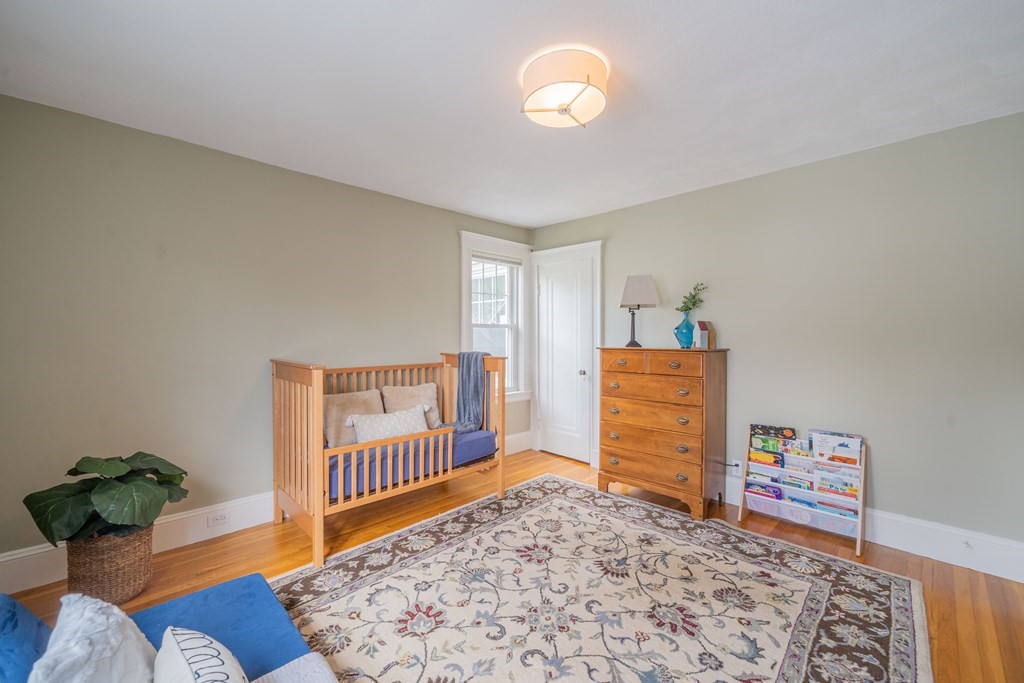 7 Maynard Street, Unit 2 Arlington, MA 02474 - Photo 31 of 42 a bedroom with furniture and a rug