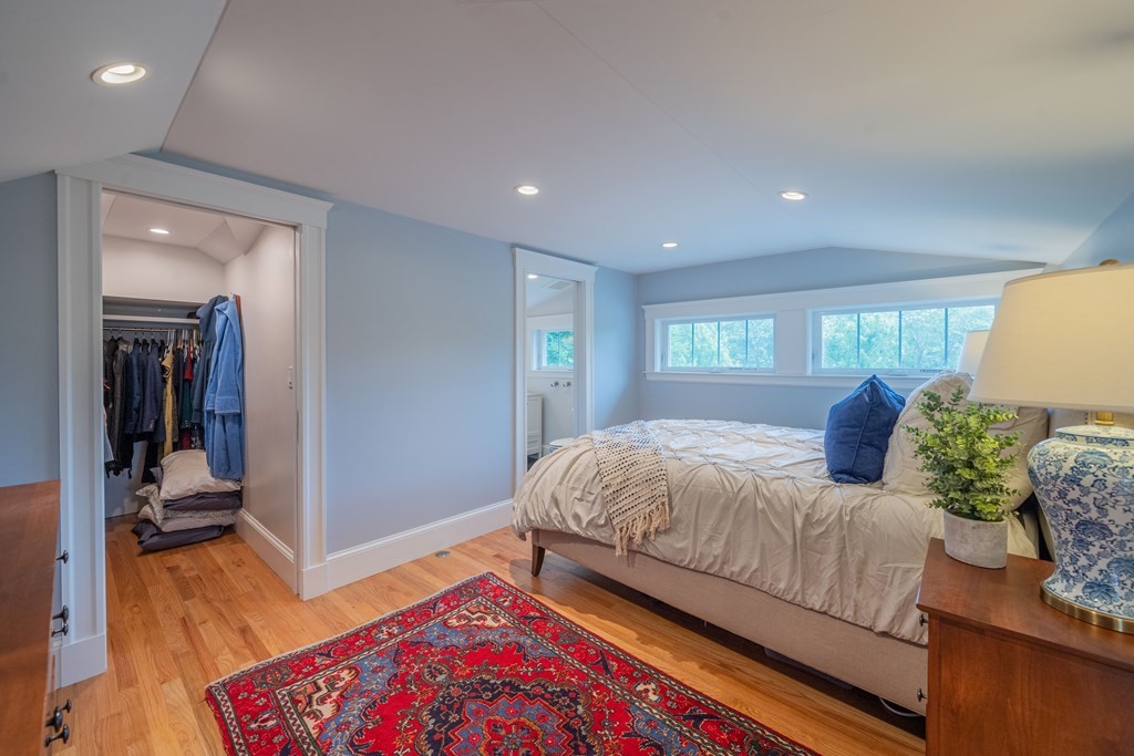 7 Maynard Street, Unit 2 Arlington, MA 02474 - Photo 36 of 42 a bedroom with a bed and wooden floor