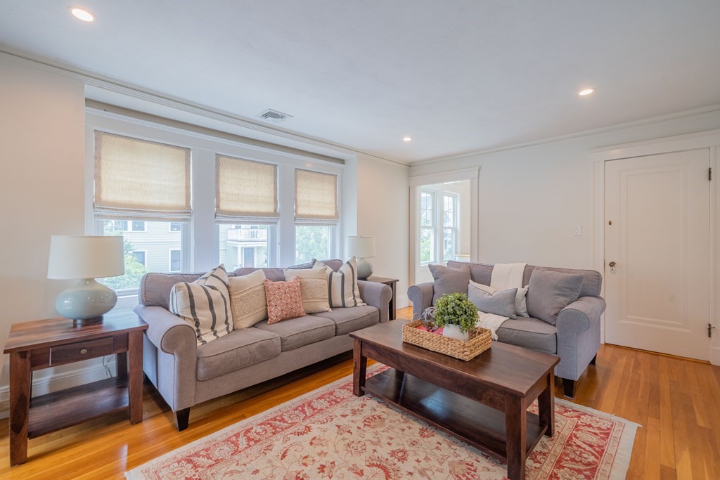 7 Maynard Street, Unit 2 Arlington, MA 02474 - Photo 6 of 42 a living room with furniture and a large window