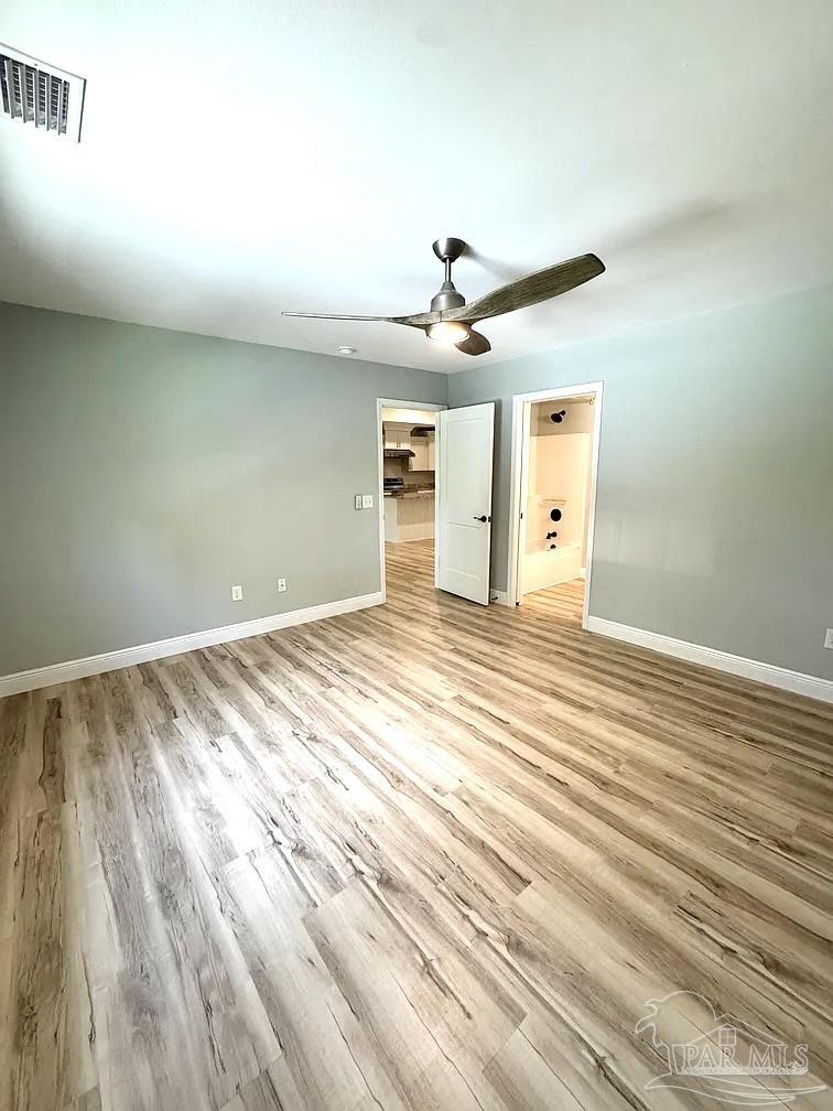 1910 West Kingsfield Road Cantonment, FL 32533 - Photo 7 of 8 en empty room with wooden floor and ceiling fan