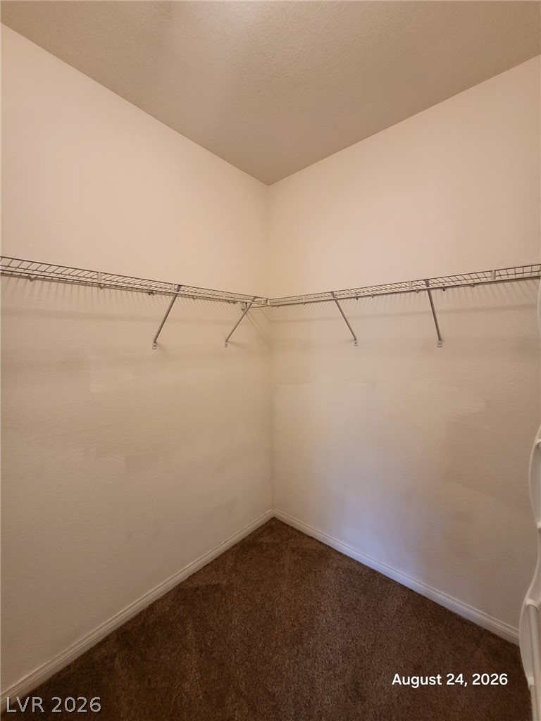 7701 West Robindale Road, Unit 125 Las Vegas, NV 89113 - Photo 13 of 16 High ceilings and built-in wire shelving maximize storage within this carpeted closet.