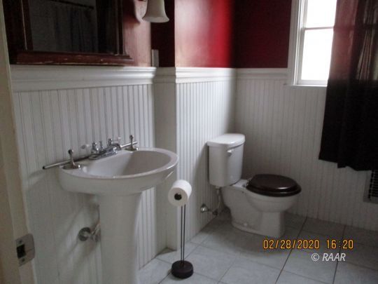 336 North Sanders Street Ridgecrest, CA 93555 - Photo 15 of 18 a bathroom with a toilet a sink and a window
