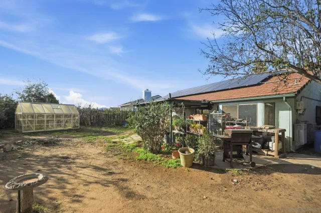 a view of a chairs and table in the backyard