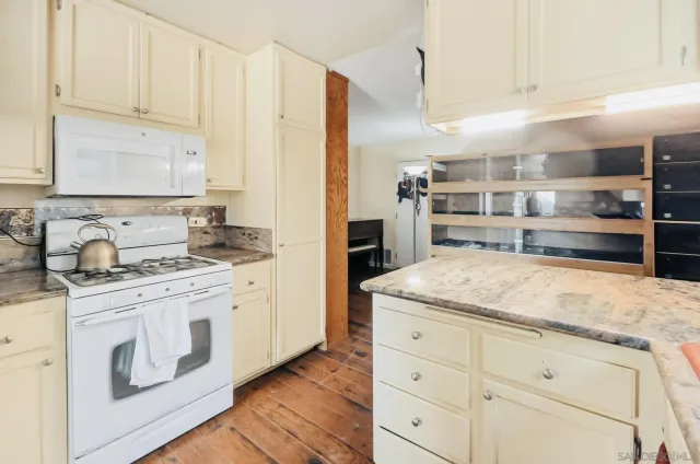 a kitchen with stainless steel appliances granite countertop a sink and cabinets