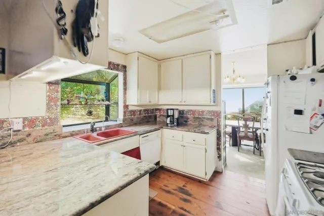 a kitchen with a stove a refrigerator and a sink