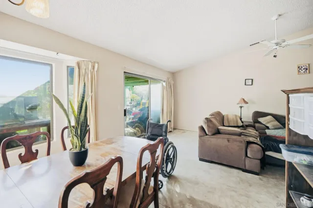 a living room with furniture and a floor to ceiling window
