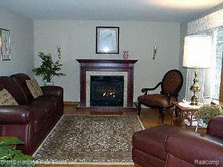 6400 Layton Road Fowlerville, MI 48836 - Photo 5 of 18 Living room w/fireplace