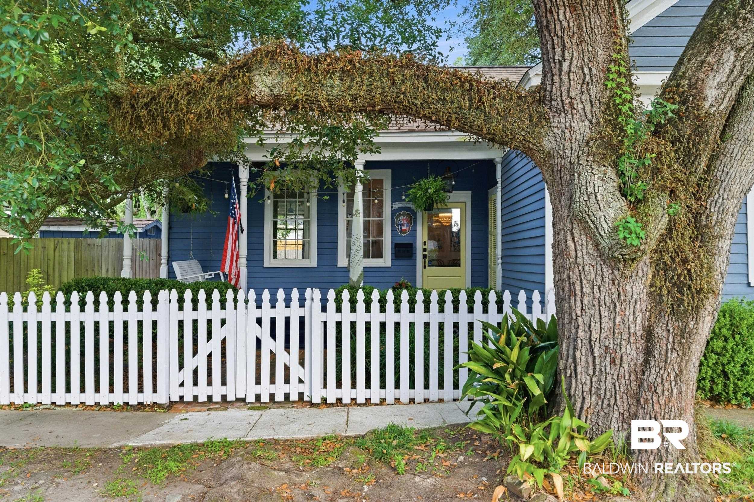 350 Charles Street Mobile, AL 36604 - Photo 2 of 52 Classic blue siding exterior with a white picket fence and gate
