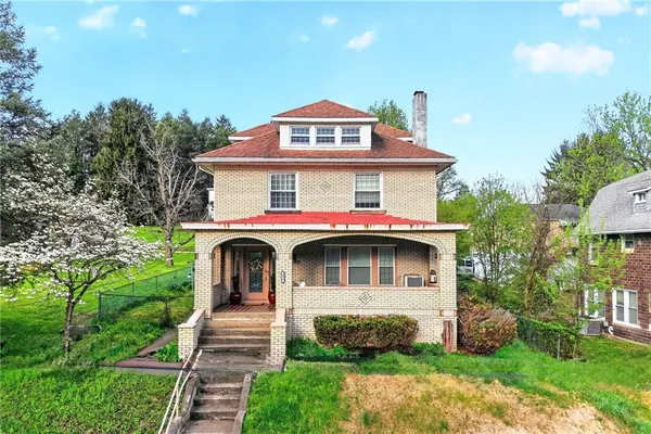 a front view of a house with garden