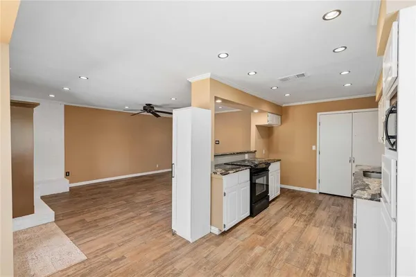 a kitchen with granite countertop a stove and a refrigerator