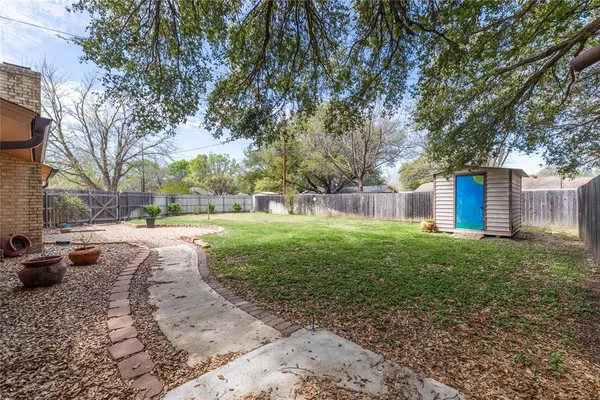 a view of a yard with a large tree