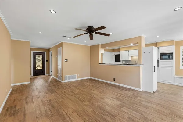 a view of a livingroom with an empty space and a ceiling fan window