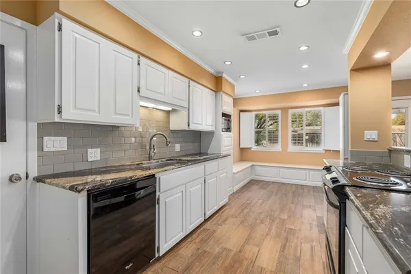 a kitchen with stainless steel appliances granite countertop a stove and a sink
