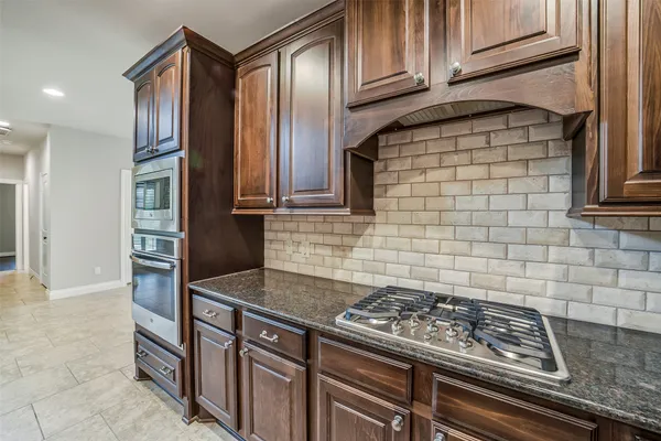 a kitchen with granite countertop stainless steel appliances and cabinets