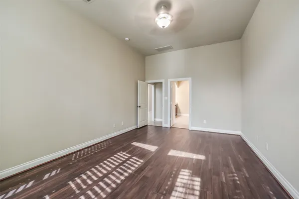 a view of an empty room and wooden floor