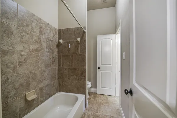 a bathroom with a tub and a shower