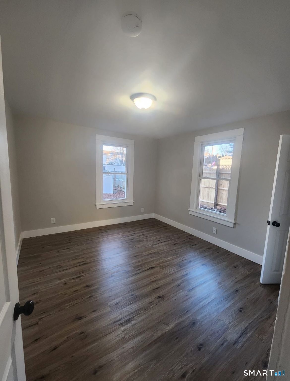 282 Ward Street Wallingford, CT 06492 - Photo 6 of 6 an empty room with wooden floor and windows