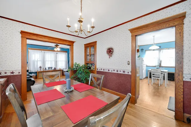 a view of a dining room with furniture and a chandelier
