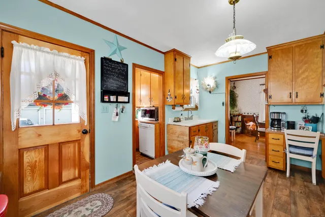 a living room with dining table and a large window