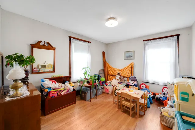 a living room with furniture kitchen view and a window