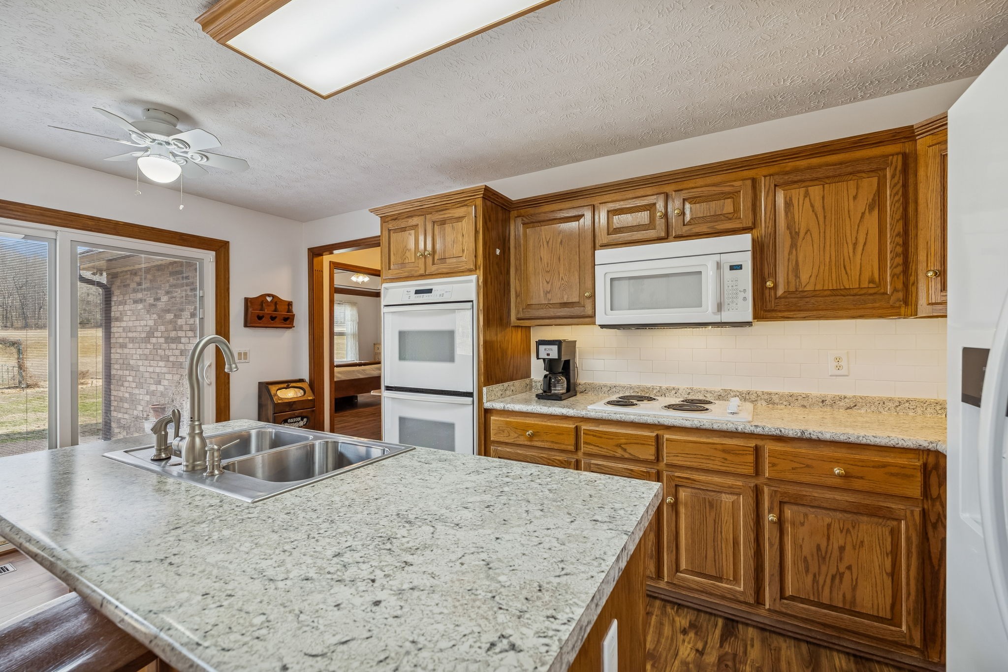 1457 Absher Branch Road Westmoreland, TN 37186 - Photo 21 of 74 a kitchen with stainless steel appliances granite countertop sink stove and refrigerator