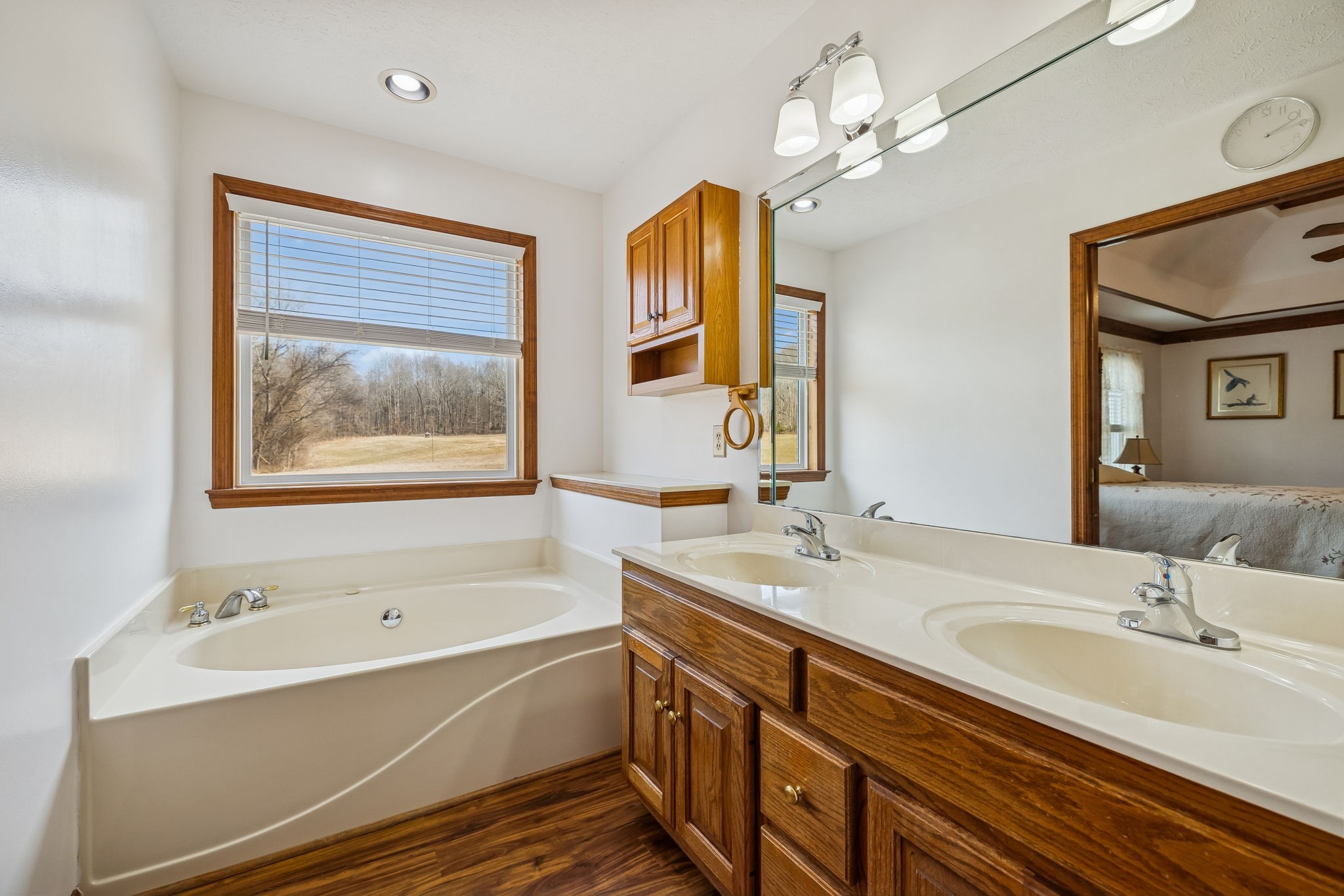 1457 Absher Branch Road Westmoreland, TN 37186 - Photo 27 of 74 a bathroom with a tub double sink window and mirror